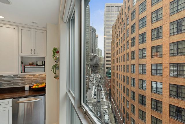 a kitchen with a refrigerator a stove and a sink with wooden floor