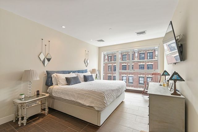 a bedroom with a bed and a couch