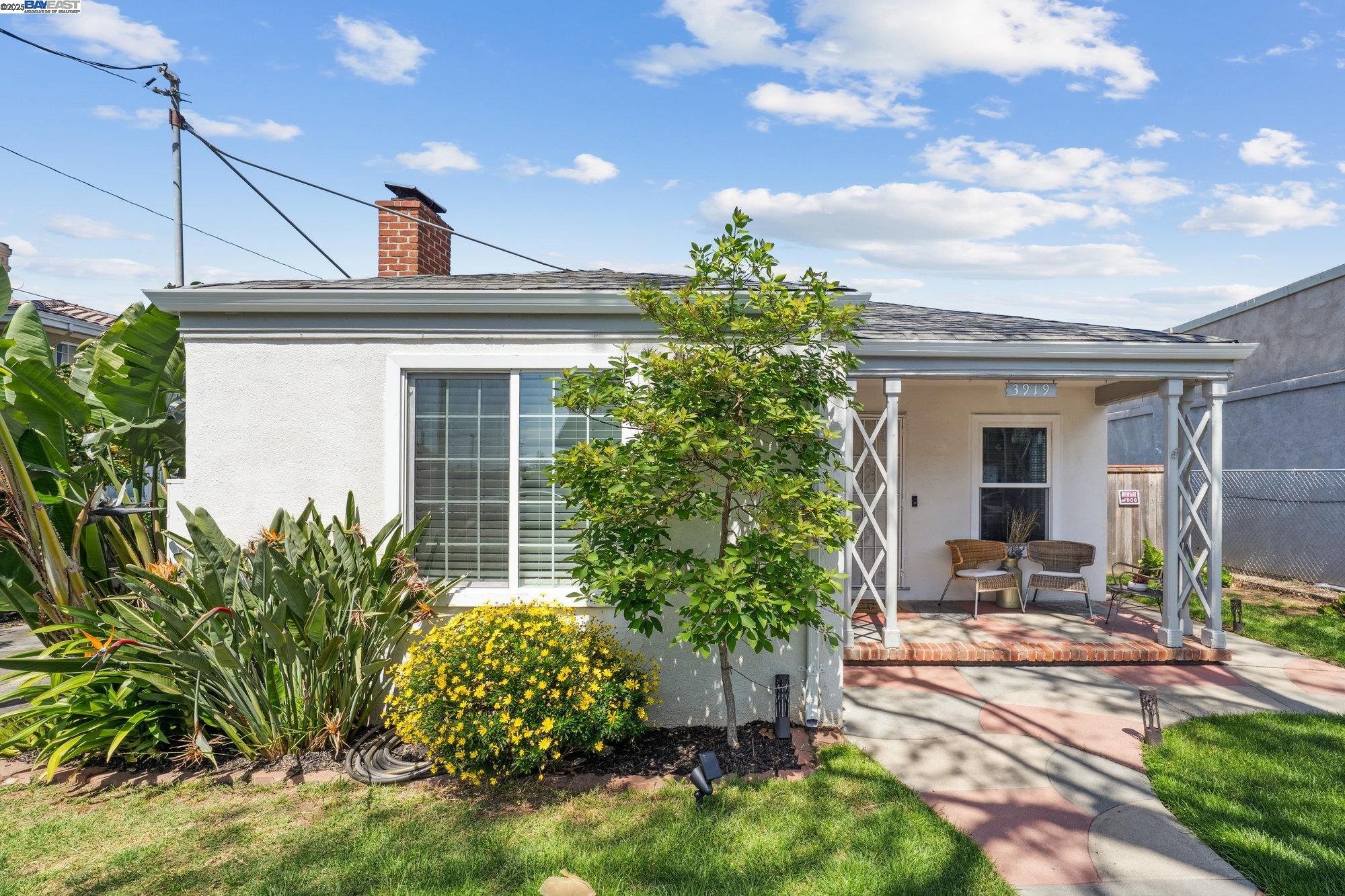 a view of a house with sitting area and garden