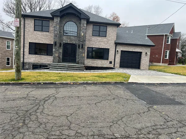 a view of a house with swimming pool and a yard