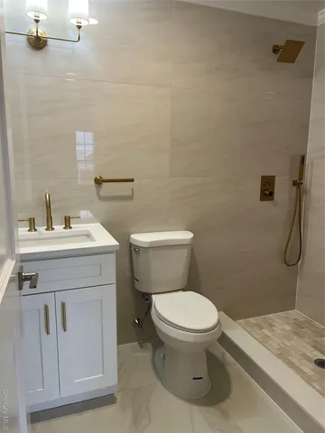 a bathroom with a sink toilet and shower
