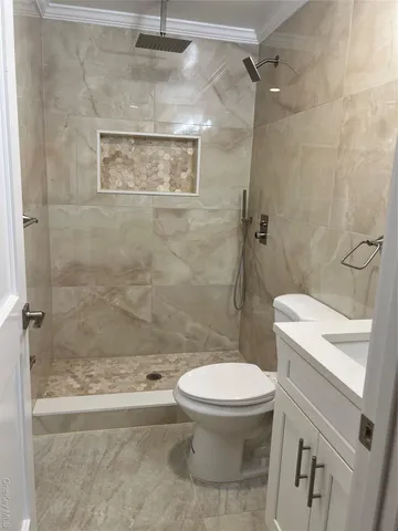 a bathroom with a toilet and a shower
