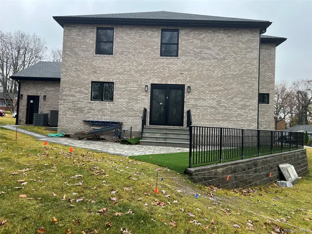 a view of a house with a yard and sitting area