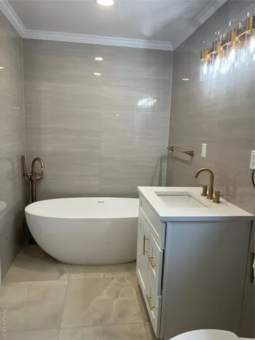 a white bath tub sitting next to a white sink