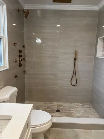a bathroom with a toilet and shower