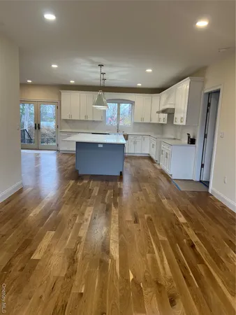 a large kitchen with stainless steel appliances granite countertop a granite counter tops and a stove