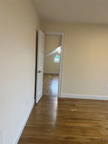 a view of a room with wooden floor