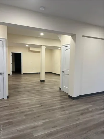 a view of an empty room and wooden floor