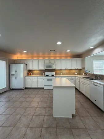 a kitchen with stainless steel appliances granite countertop a sink and cabinets