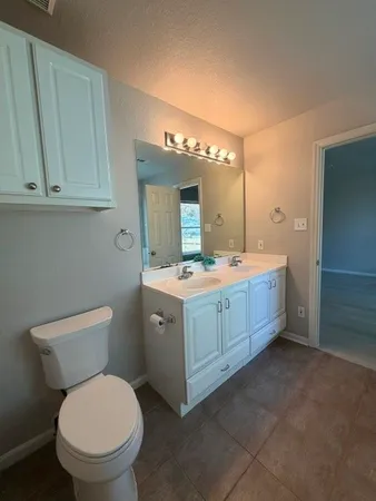 an empty room with a ceiling fan and window