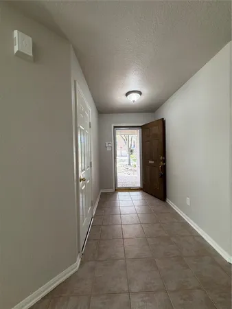 an empty room with windows and entrance