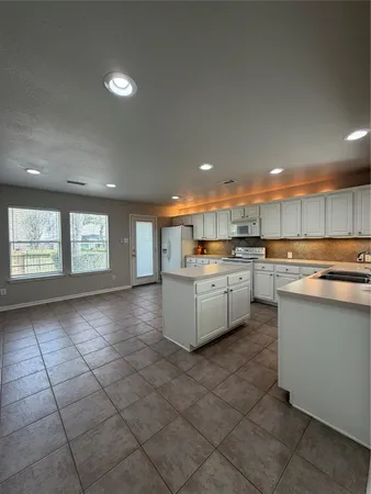 a view of a kitchen with a sink and cabinets