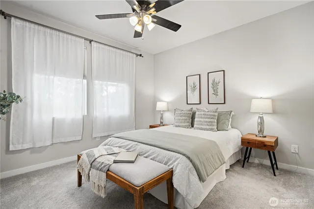 a bedroom with a bed and a lamp