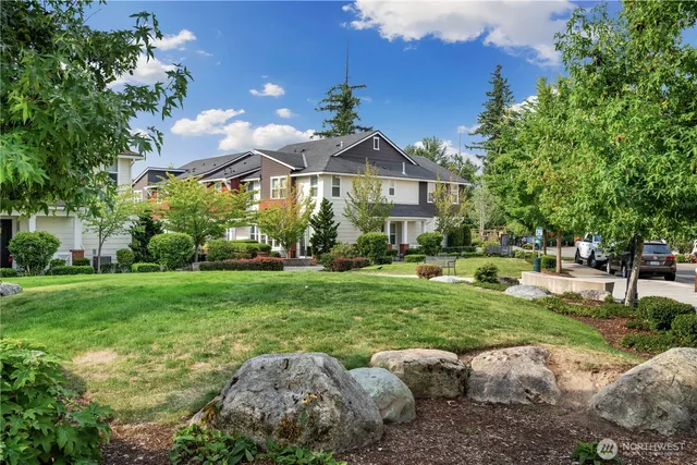 an aerial view of a house with a yard and a fountain