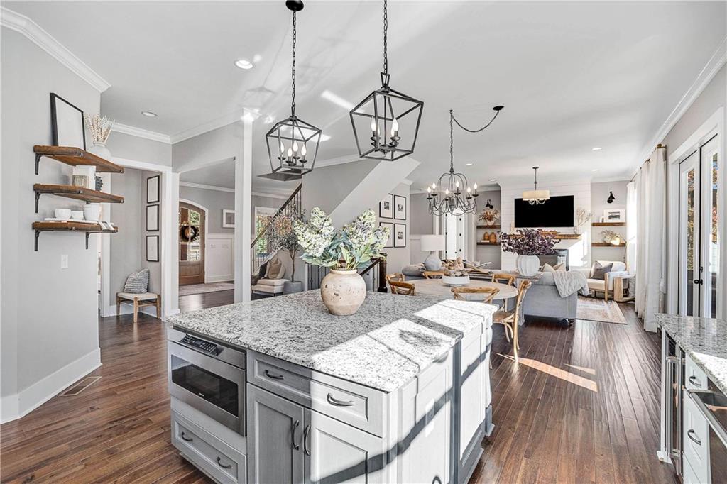 9245 Brumbelow Road Alpharetta, GA 30022 - Photo 14 of 50 a view of a dining room and livingroom with furniture wooden floor a chandelier