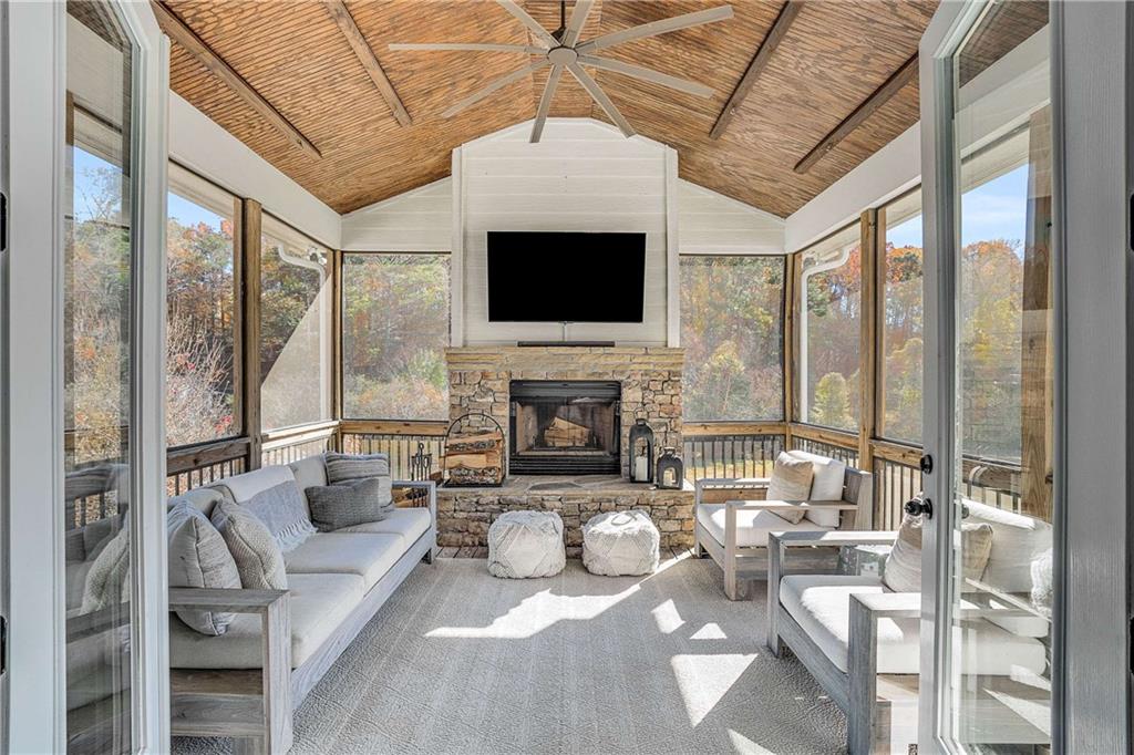 9245 Brumbelow Road Alpharetta, GA 30022 - Photo 17 of 50 a living room with furniture a flat screen tv and a fireplace