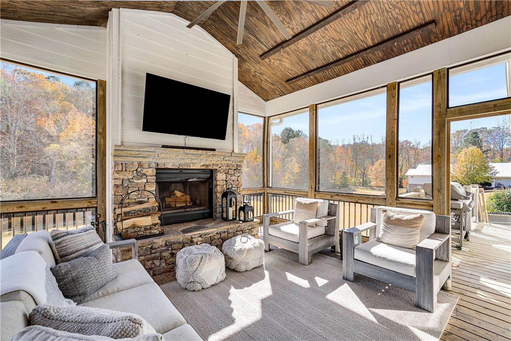 9245 Brumbelow Road Alpharetta, GA 30022 - Photo 18 of 50 a living room with furniture fireplace and a flat screen tv