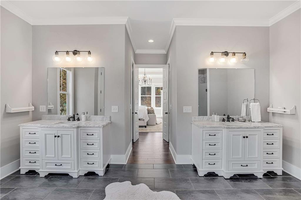9245 Brumbelow Road Alpharetta, GA 30022 - Photo 23 of 50 a spacious bathroom with a double vanity sink double and a mirror