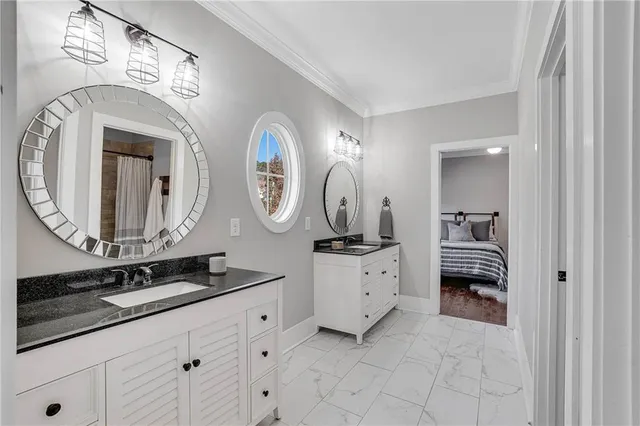 a en suite bathroom with a double vanity sink and a mirror