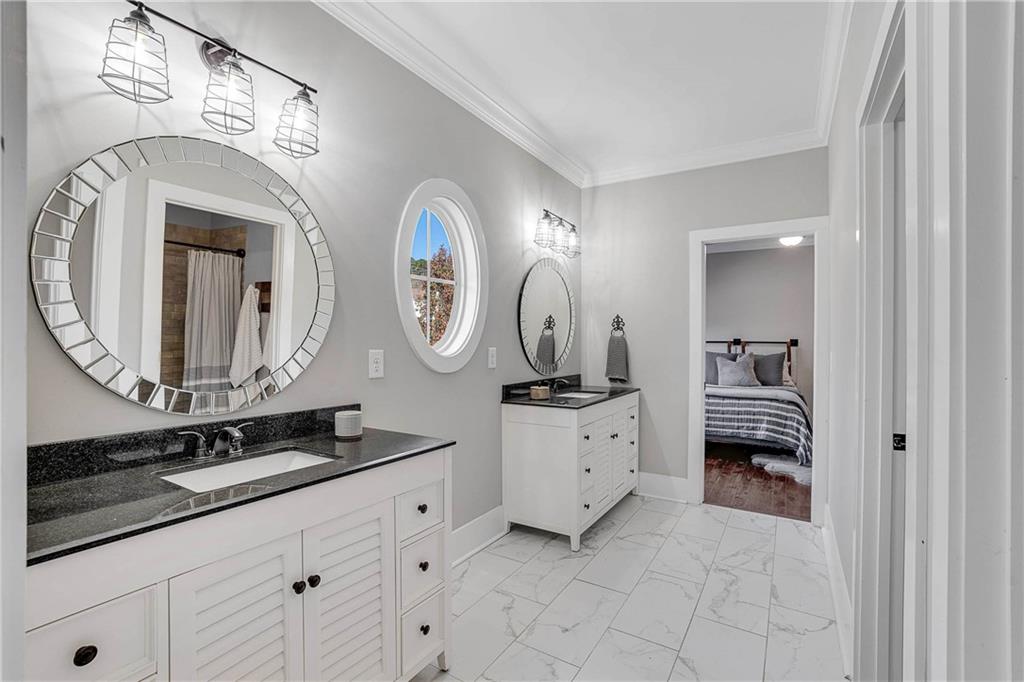 9245 Brumbelow Road Alpharetta, GA 30022 - Photo 28 of 50 a en suite bathroom with a double vanity sink and a mirror