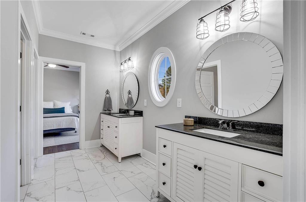 9245 Brumbelow Road Alpharetta, GA 30022 - Photo 29 of 50 a spacious bathroom with a double vanity sink and a mirror