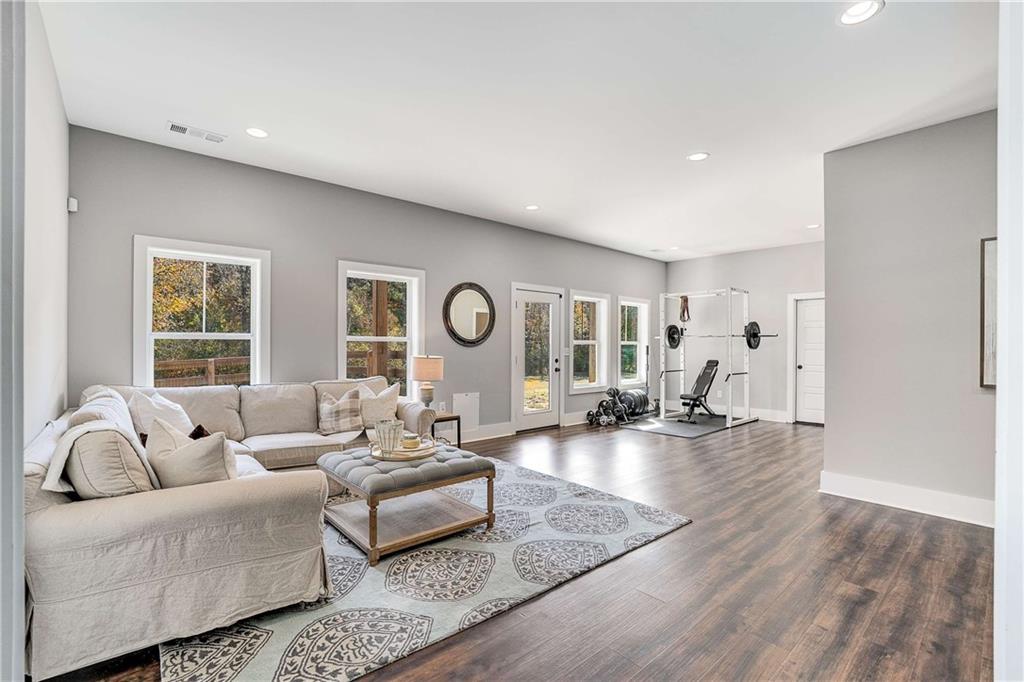 9245 Brumbelow Road Alpharetta, GA 30022 - Photo 34 of 50 a living room with furniture and wooden floor
