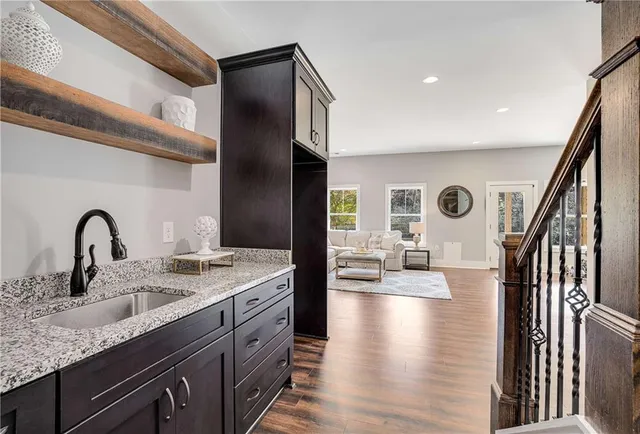 a kitchen with sink refrigerator and stove