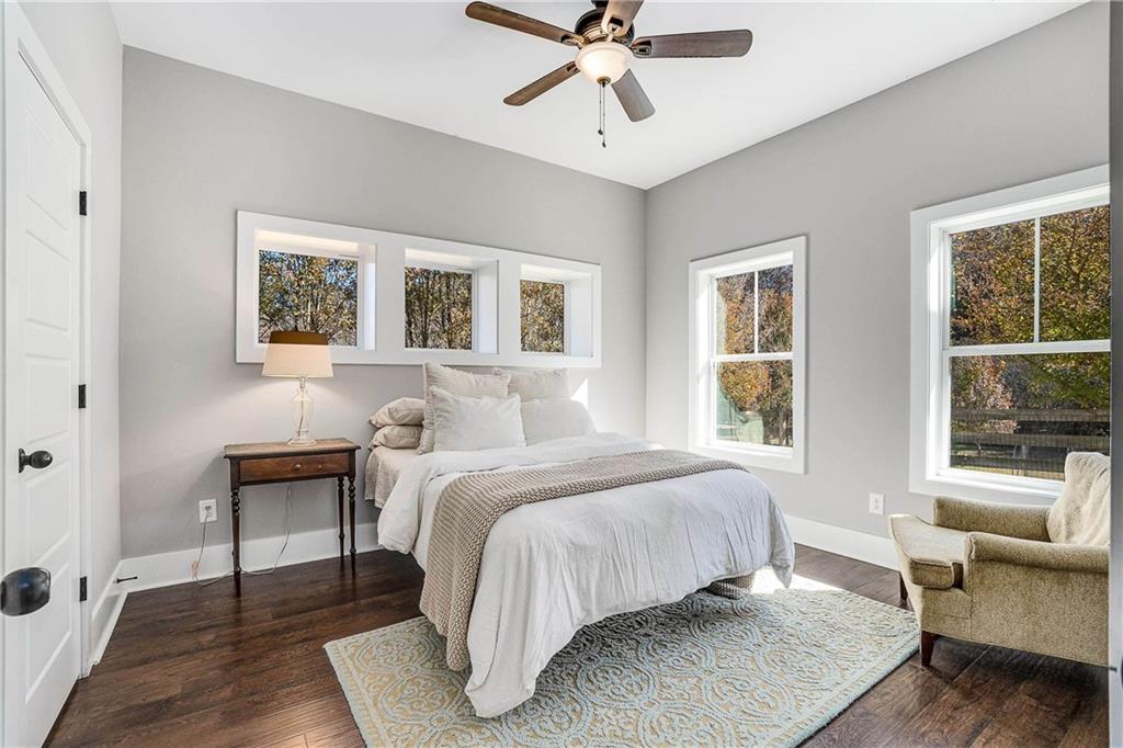 9245 Brumbelow Road Alpharetta, GA 30022 - Photo 39 of 50 a bedroom with a bed and wooden floor