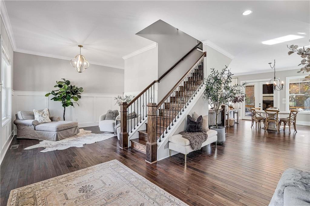 9245 Brumbelow Road Alpharetta, GA 30022 - Photo 5 of 50 a living room with furniture and wooden floor