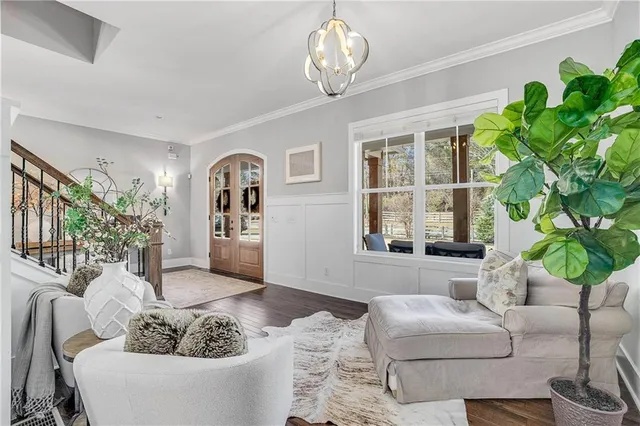 a living room with furniture potted plant and a window