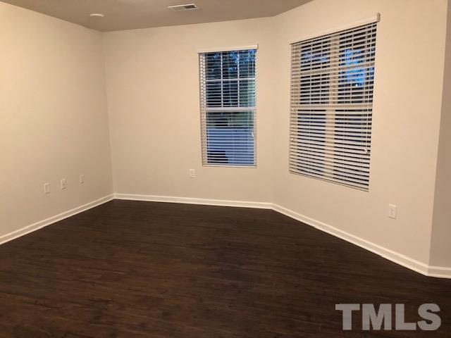 6033 Beale Loop Raleigh, NC 27616 - Photo 3 of 16 a view of an empty room with wooden floor and a window