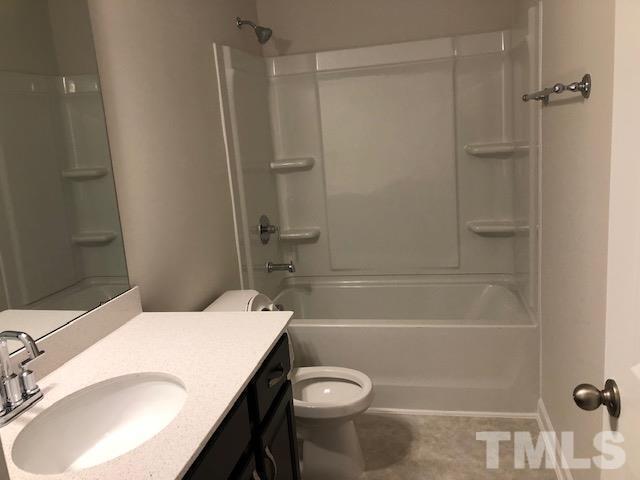 6033 Beale Loop Raleigh, NC 27616 - Photo 8 of 16 a bathroom with a sink a toilet and shower