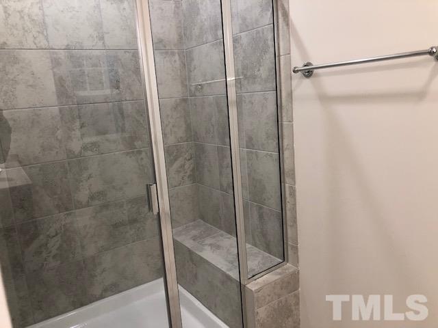 6033 Beale Loop Raleigh, NC 27616 - Photo 9 of 16 a bathroom with a glass shower door