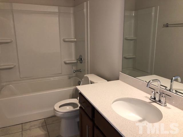 6033 Beale Loop Raleigh, NC 27616 - Photo 10 of 16 a bathroom with a granite countertop sink toilet and shower