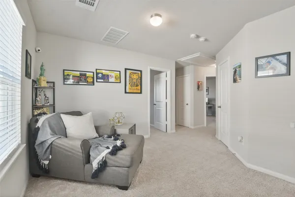 a living room with furniture and a baby crib