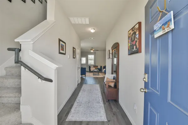 a view of a hallway with a living room