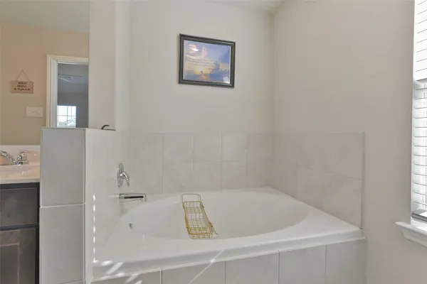 a bath tub sitting next to a white sink