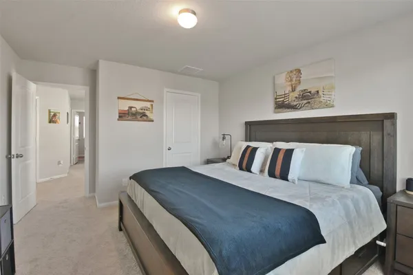 a bed room with a bed and a painting