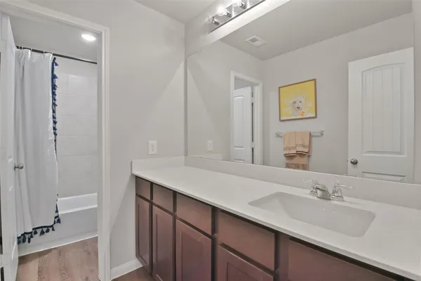 a bathroom with a double vanity sink mirror and shower