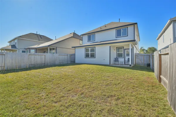 a view of a house with a backyard