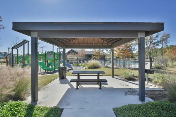 a view of a patio with a table and chairs under an umbrella