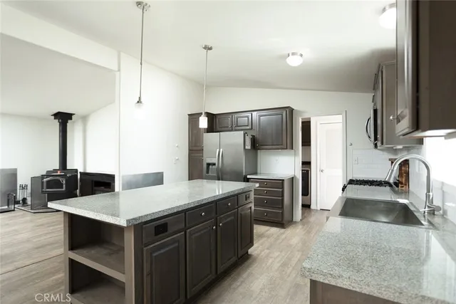 a kitchen with a refrigerator a sink and a stove