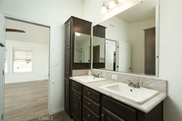 a bathroom with a double vanity sink and a mirror