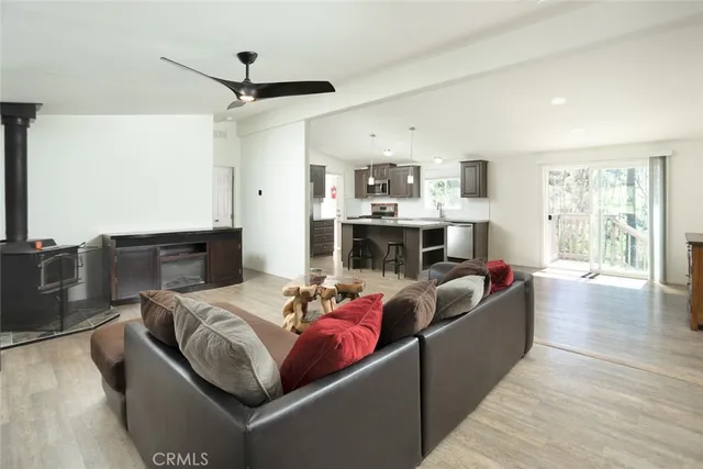 a living room with furniture large window and flat screen tv