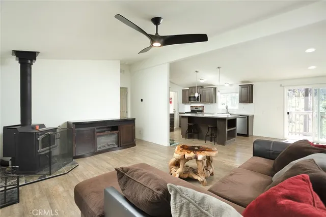 a living room with furniture kitchen view and a fireplace
