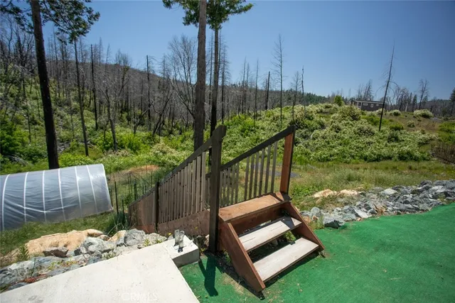 a backyard of a house with table and chairs