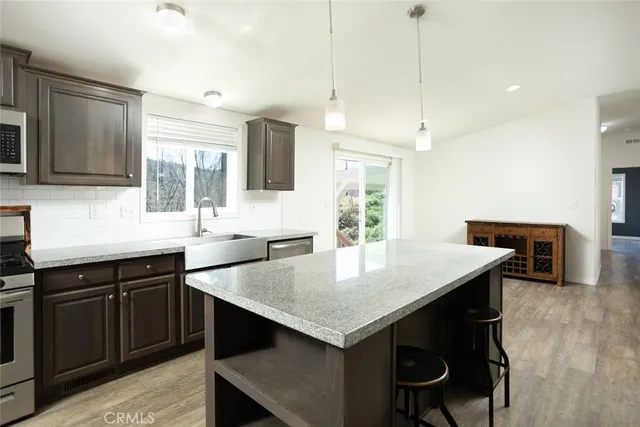a kitchen with a stove a sink and a refrigerator