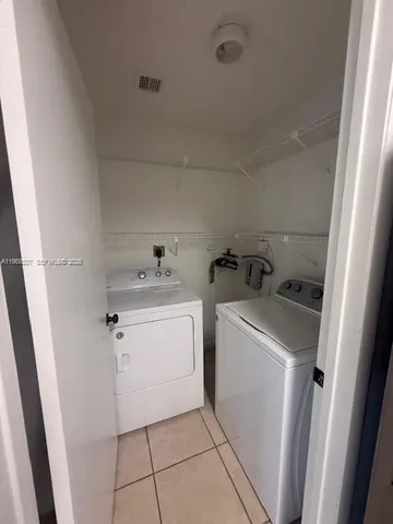 a utility room with cabinets washer and dryer