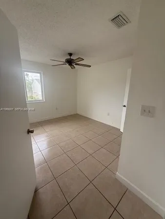 a view of an empty room and a window
