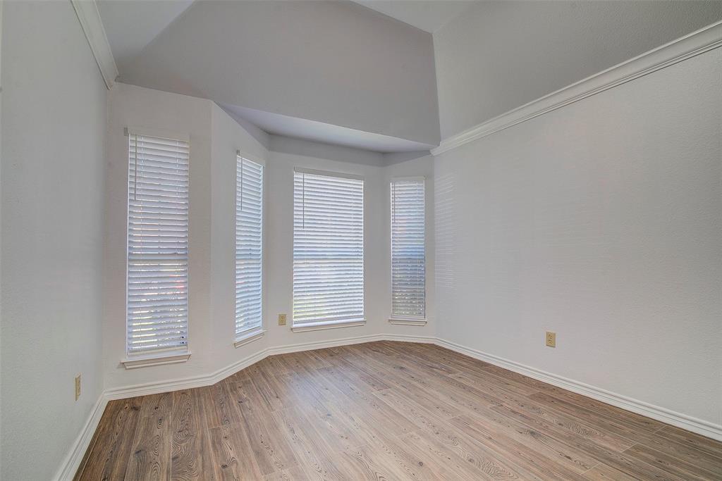 815 Fairlawn Street Allen, TX 75002 - Photo 11 of 22 an empty room with wooden floor and windows